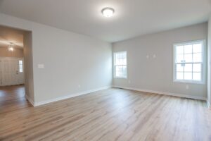 Empty room with light wood flooring, beige walls, and windows—perfect for new homes in Richmond VA.