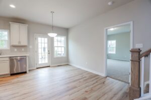 Bright kitchen and dining area with wood floors, white cabinets—perfect for new homes in Richmond VA.
