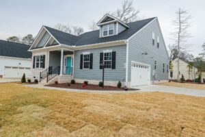 A modern gray house with white trim and a porch—perfect for those seeking new homes in Richmond VA.