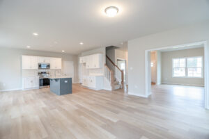 Spacious modern home interior in Lot 32, featuring an open kitchen, hardwood floors, and ample natural light.
