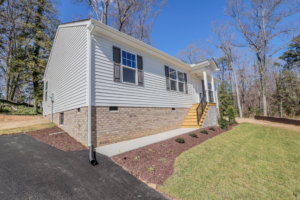 Single-story house with gray siding and brick foundation—perfect for buyers seeking new homes in Richmond VA.