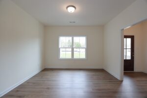 Empty room with light walls, wood flooring, and window—perfect for new homes in Richmond VA.