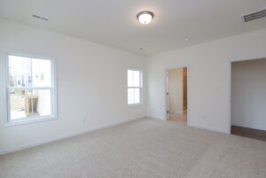 Empty room with beige carpet, white walls, and windows—perfect for those seeking new homes in Richmond VA.
