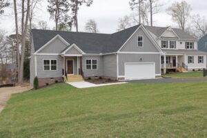 Single-story gray house with white trim and garage, ideal for those seeking new homes in Richmond VA.