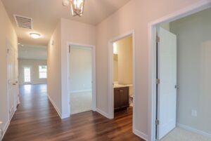 Bright hallway with wooden floors, leading to living and bedrooms—perfect for new homes in Richmond VA.