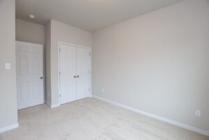 Empty room with beige carpet, white walls, and closet—perfect for new homes in Richmond VA.