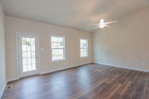 Empty room with wood flooring, ceiling fan, and glass door—perfect for new homes in Richmond VA.