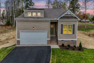 Single-story house with a two-car garage and landscaped yard—perfect for those seeking new homes in Richmond VA.
