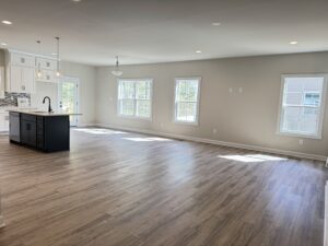 Spacious, bright empty room with wood floors in one of the stunning new homes in Richmond VA.