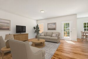 Bright living room in Patrick Henry Heights with sofa, TV, and large windows—featured in Lot 57.