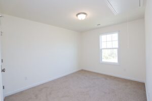 Bright, empty room with beige carpet—perfect for new homes in Richmond VA seeking comfort and style.