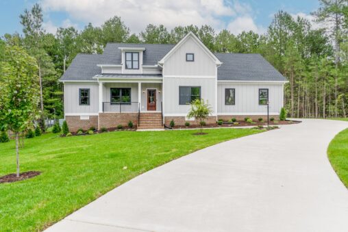 Modern white house with a front porch and curved driveway—perfect for those seeking new homes in Richmond VA.