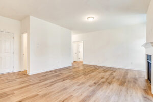 A room with a wood floor and white walls in Poplar Village Lot 29.