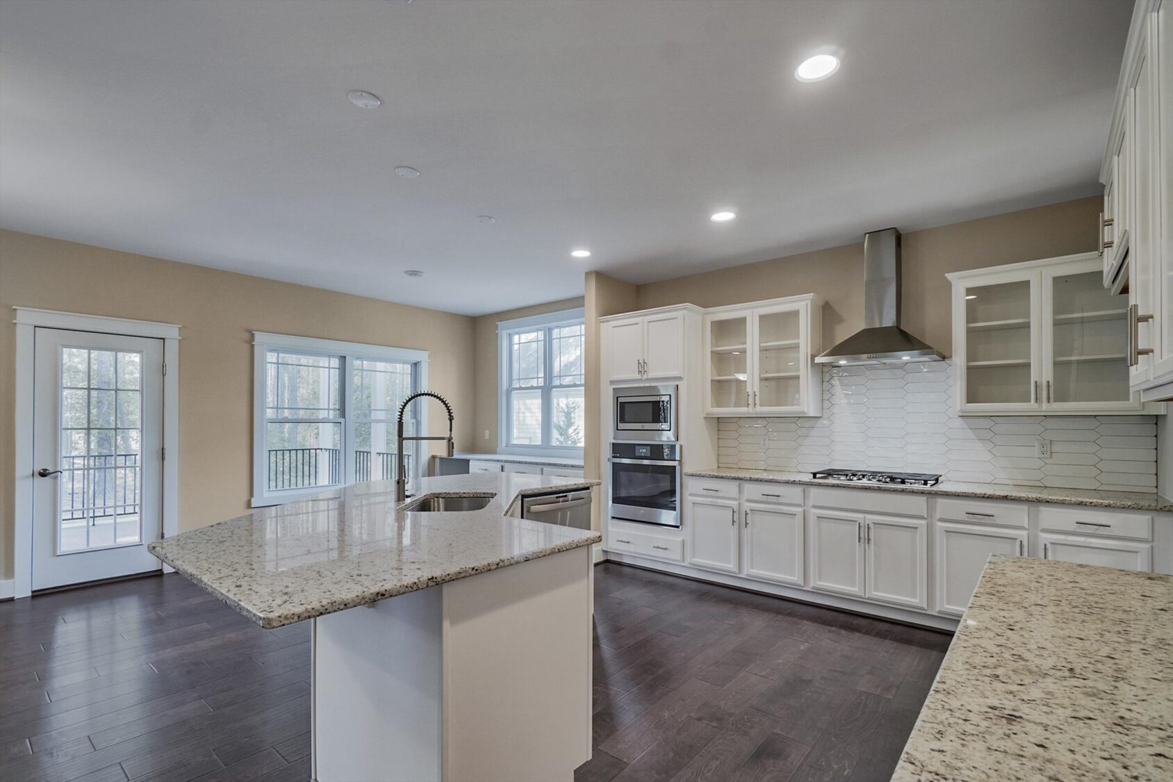 Modern kitchen in Poplar Village with white cabinets, granite countertops, and stainless steel appliances in Albany.