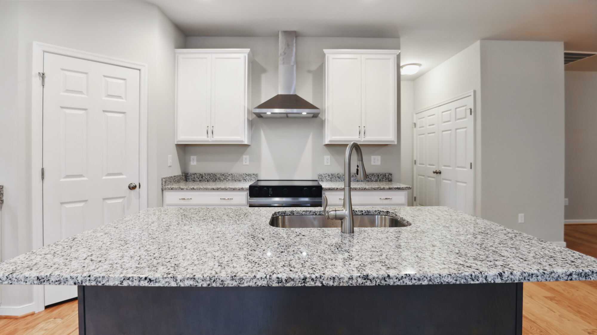 A Bethany kitchen with a sleek granite countertop offers modern style and Somerset Hill elegance.
