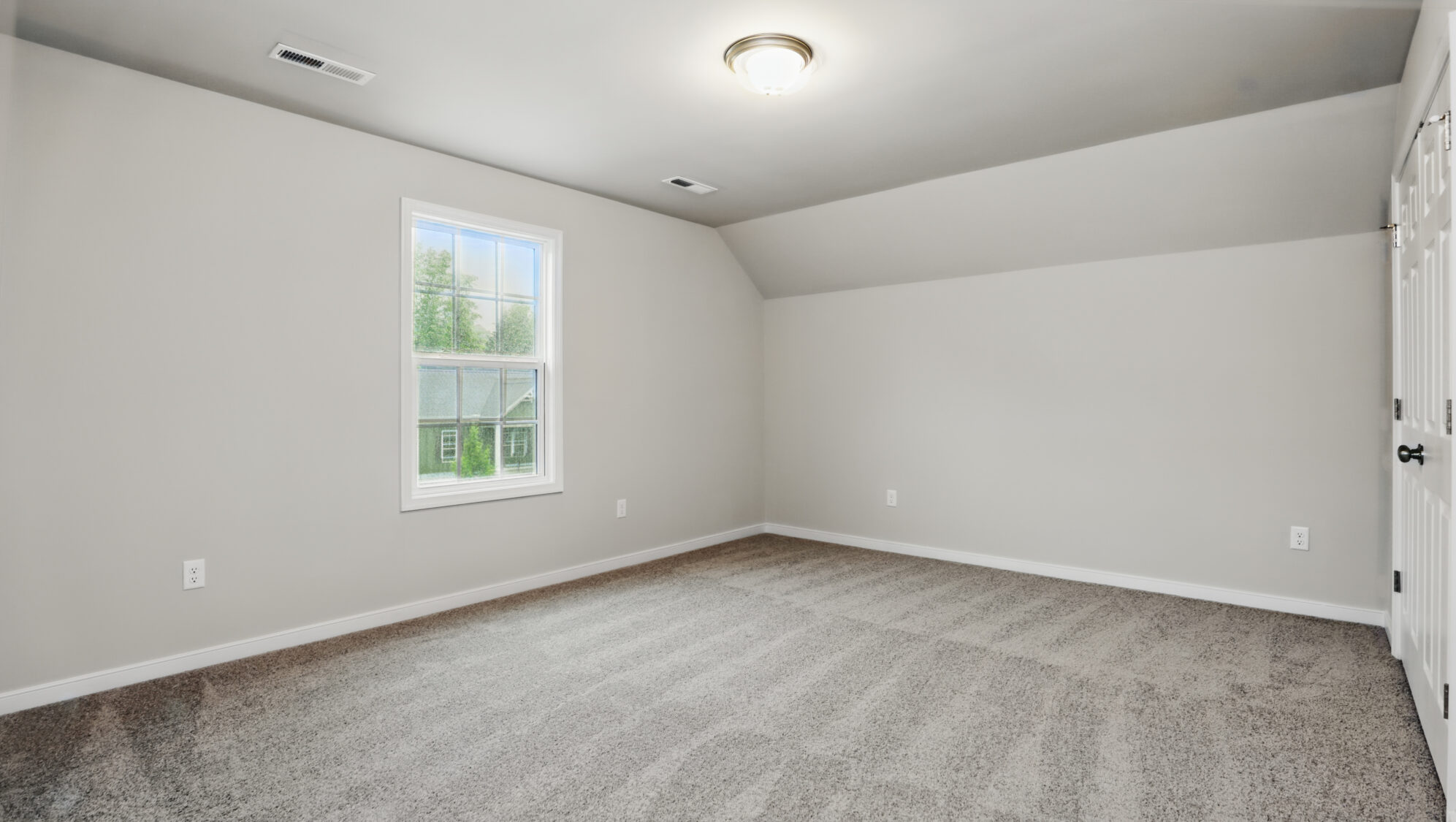 Empty Somerset Hill room with gray walls, beige carpet, ceiling light, and a Bethany window view.