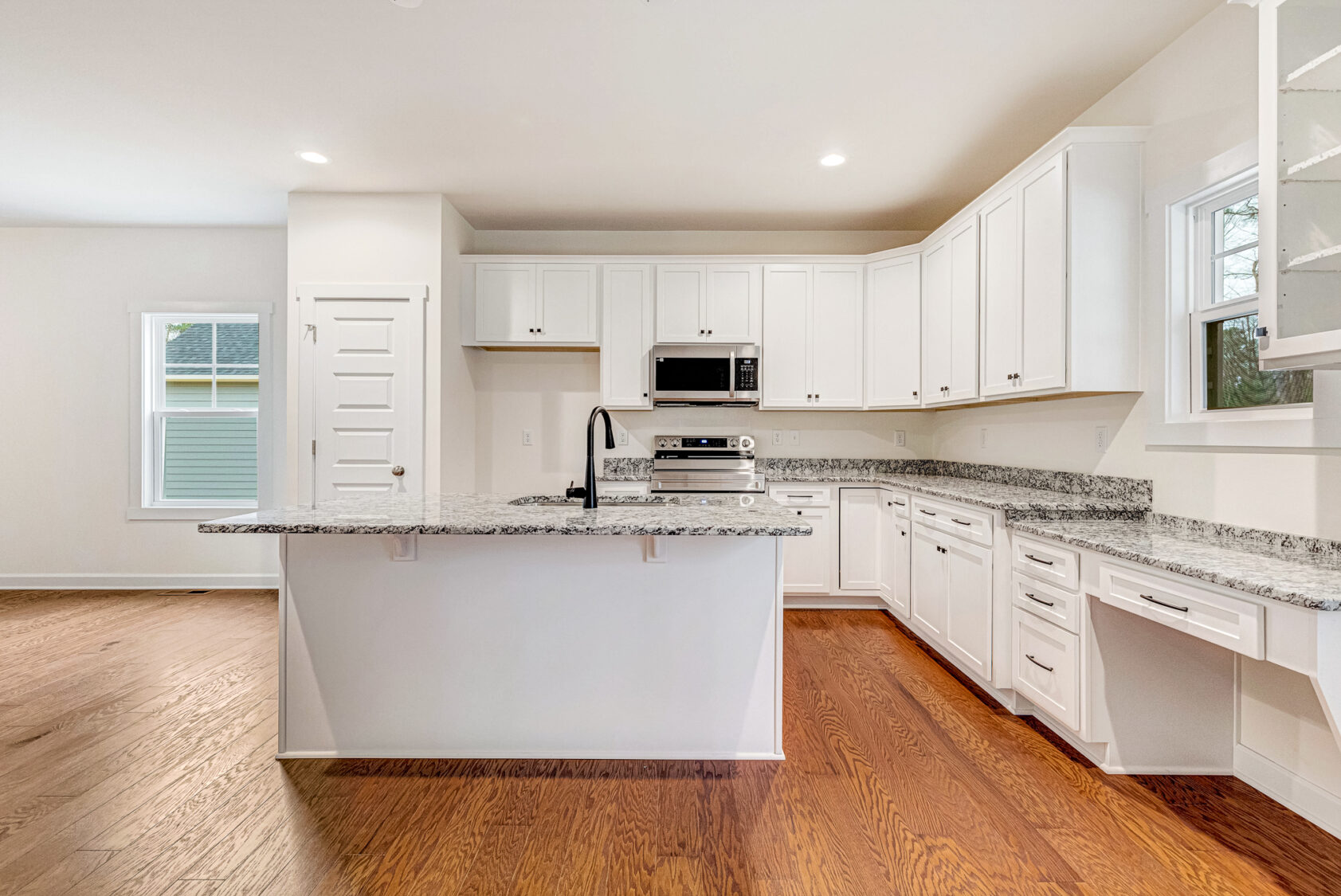 Bright modern Somerset Hill kitchen with white cabinets, granite countertops, and stainless appliances—listed by Kate.
