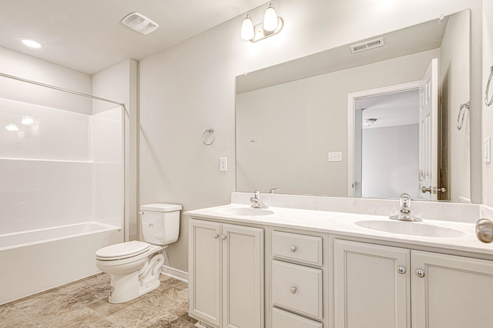 Bright Somerset Hill bathroom with double sinks, large mirror, and neutral palette—featured in Lot 8.