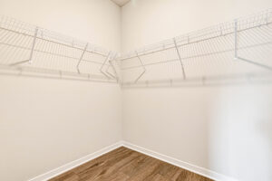 Spacious walk-in closet in Lot 4, Somerset Hill, with white wire shelves and wood-look floors on cream walls.