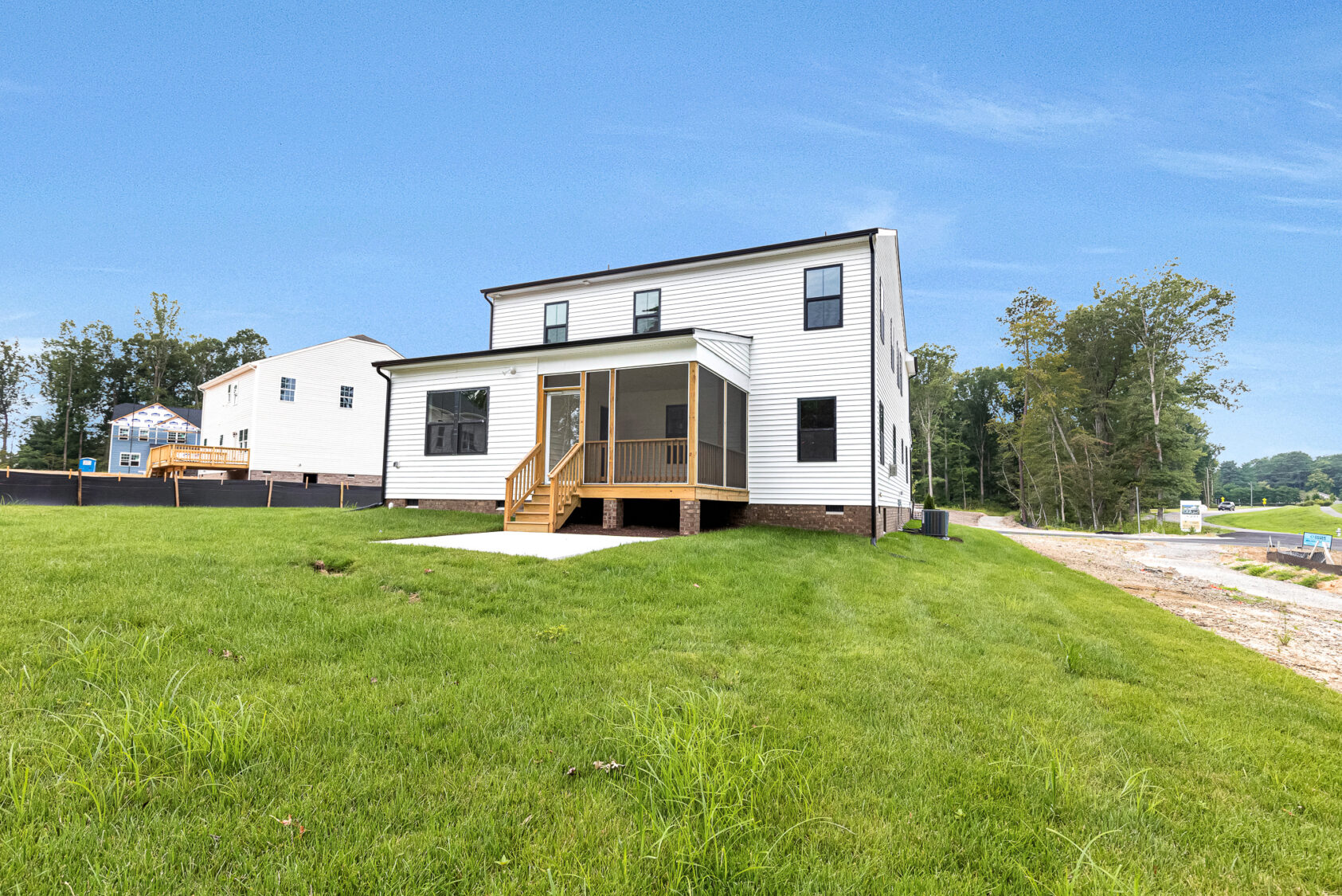 Two-story white house with screened porch on Somerset Hill, Lot 20, featuring steps and a large green lawn.